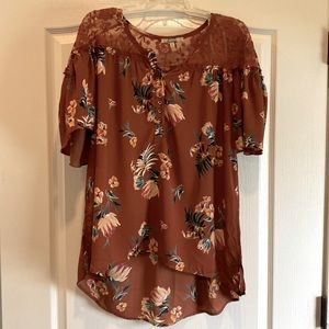 Burnt orange high low floral shirt. Cute lace detail at shoulders.